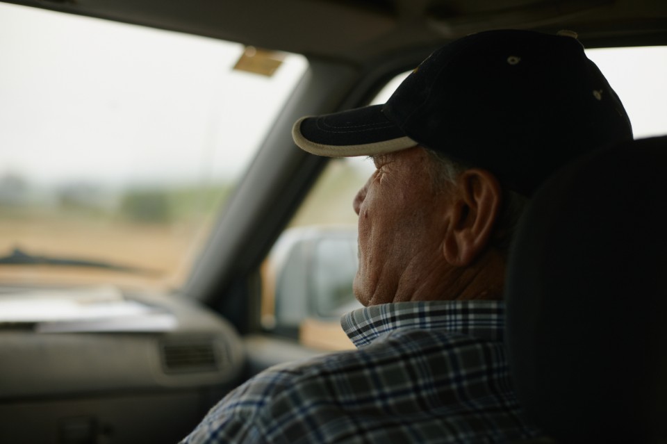 Close up portrait of a senior man inside a car